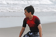 Boy plays in beach sand